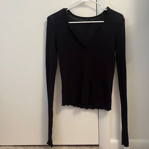 Black long sleeve out from under top.